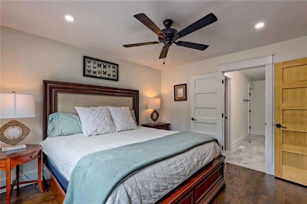 63 Redwood Lane Tiger, GA 30576 - Photo 30 of 77 a bedroom with a large bed and a chandelier