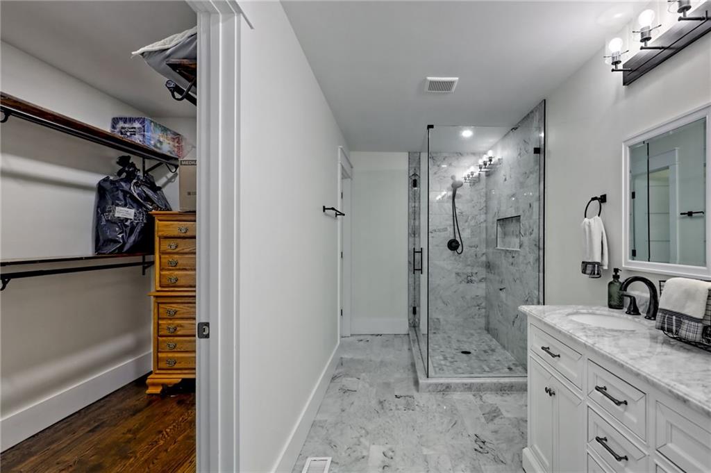63 Redwood Lane Tiger, GA 30576 - Photo 31 of 77 a bathroom with a shower sink and mirror