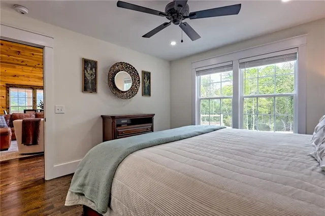 a bathroom with a granite countertop toilet sink and mirror
