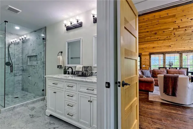 a bedroom with a granite countertop sink and a mirror
