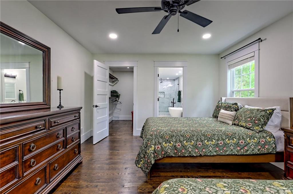 63 Redwood Lane Tiger, GA 30576 - Photo 38 of 77 a bedroom with a bed and a chandelier