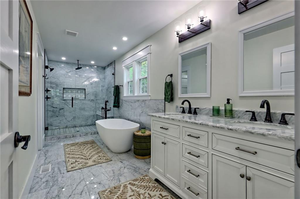 63 Redwood Lane Tiger, GA 30576 - Photo 39 of 77 a spacious bathroom with a granite countertop sink toilet a mirror and shower