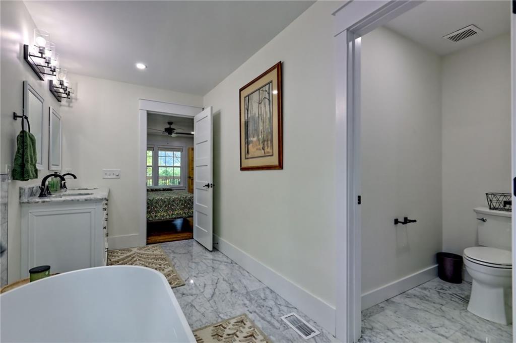 63 Redwood Lane Tiger, GA 30576 - Photo 42 of 77 a spacious bedroom with a bed and a view of bathroom