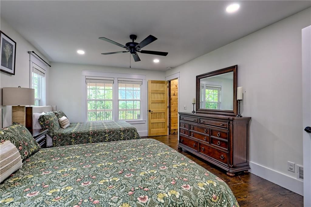 63 Redwood Lane Tiger, GA 30576 - Photo 45 of 77 a bedroom with a bed and a chandelier