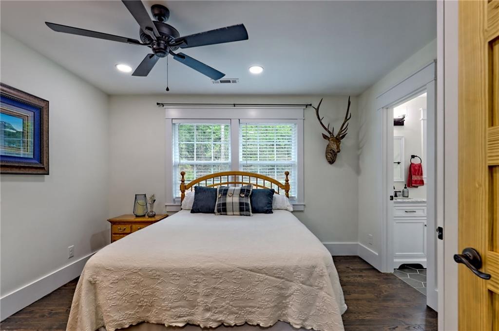 63 Redwood Lane Tiger, GA 30576 - Photo 54 of 77 a bedroom with a bed and a chandelier