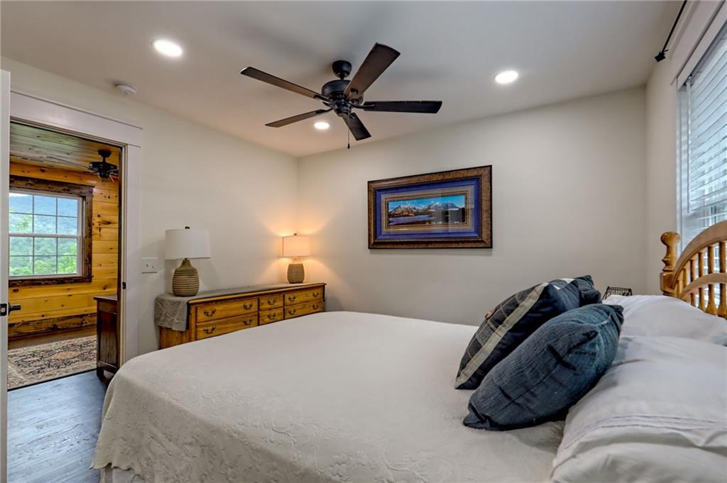 63 Redwood Lane Tiger, GA 30576 - Photo 58 of 77 a bedroom with a bed and a chandelier