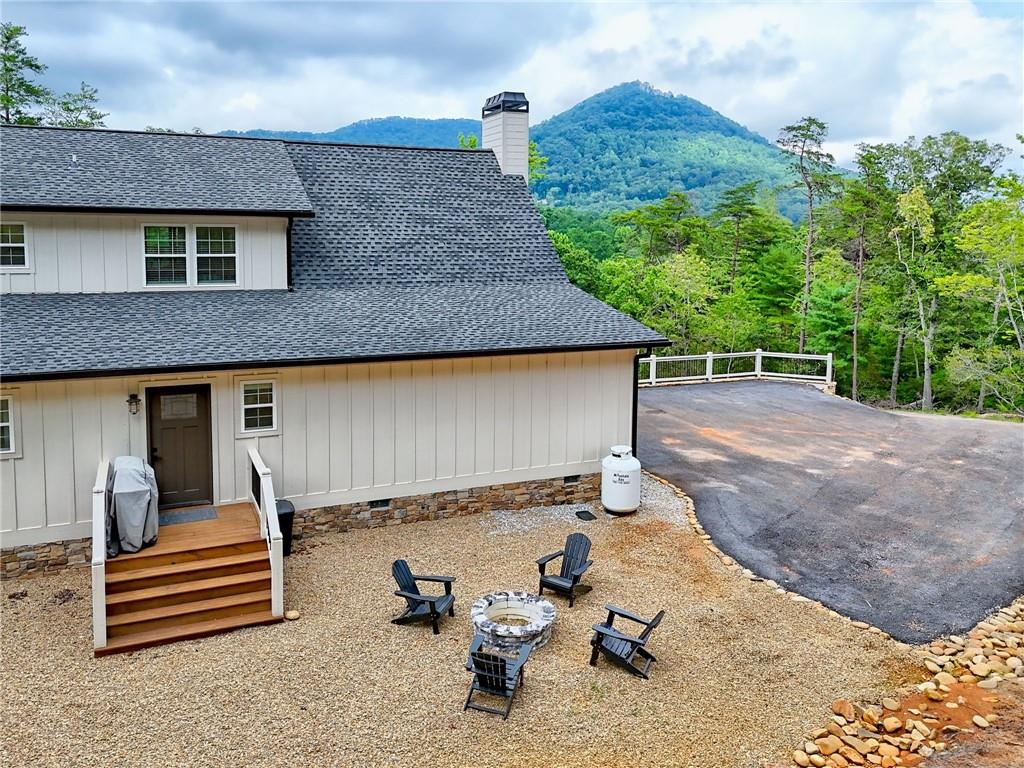 63 Redwood Lane Tiger, GA 30576 - Photo 73 of 77 a backyard of a house with barbeque oven table and chairs