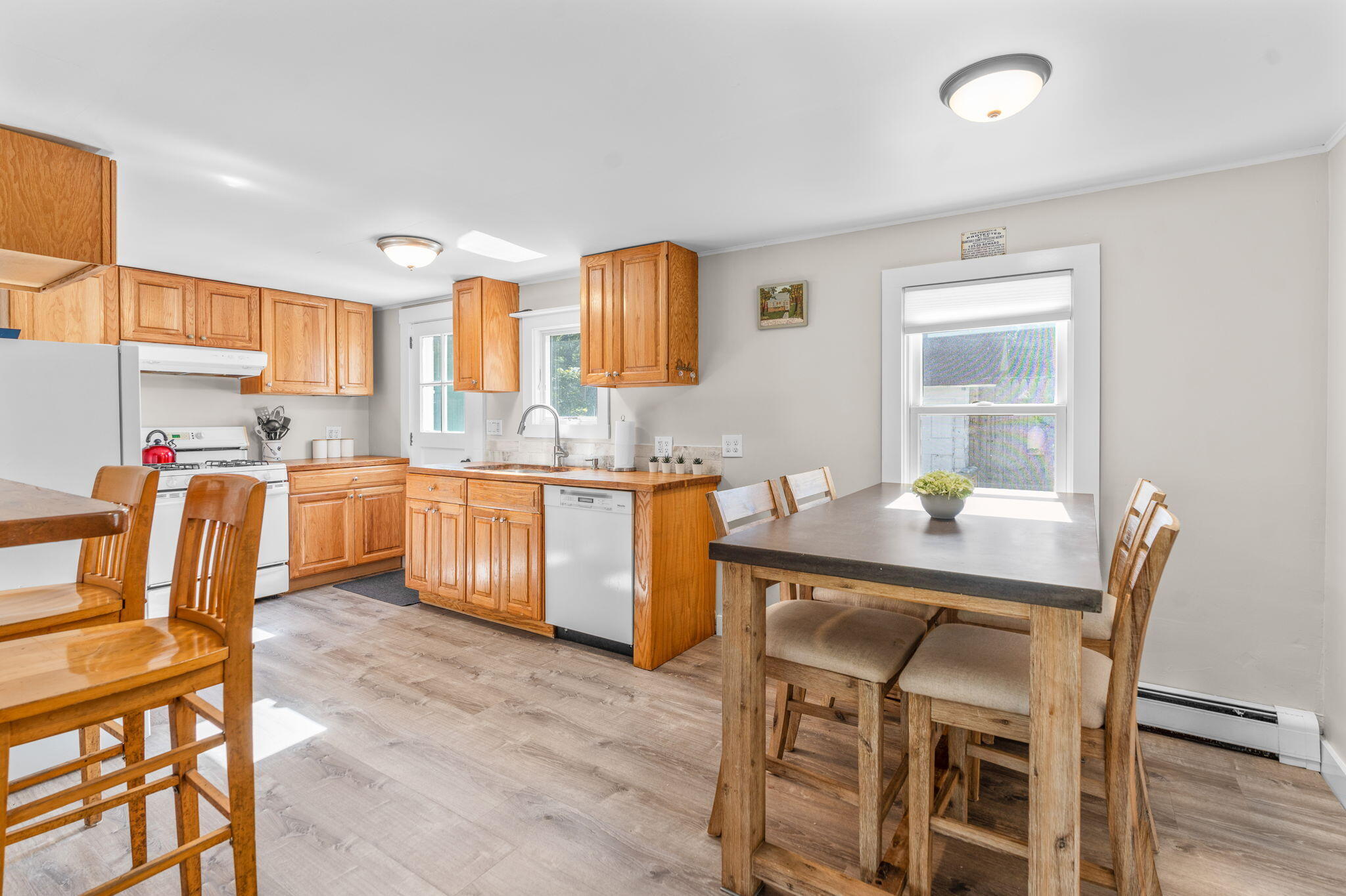 45 Indian Neck Road Wellfleet, MA 02667 - Photo 15 of 68 a kitchen with a table chairs refrigerator and microwave
