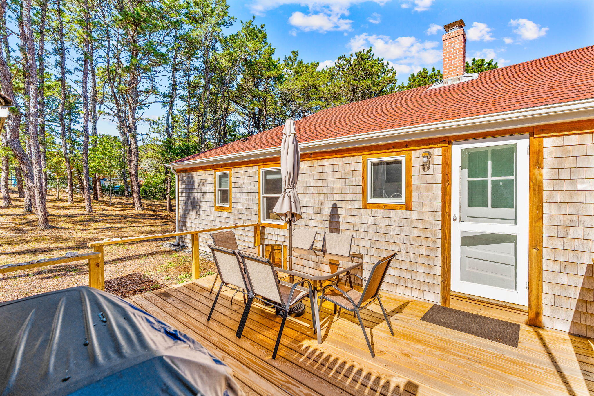 45 Indian Neck Road Wellfleet, MA 02667 - Photo 28 of 68 a view of a patio with table and chairs and couches
