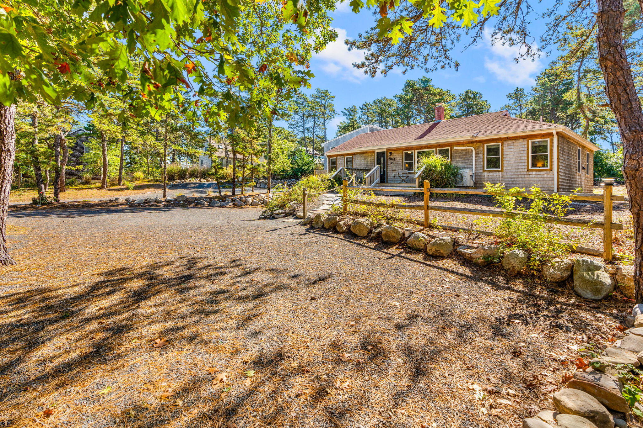 45 Indian Neck Road Wellfleet, MA 02667 - Photo 64 of 68 a front view of a house with a yard and garage