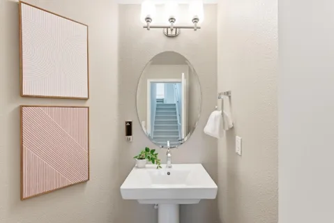 a bathroom with a sink a mirror and shower
