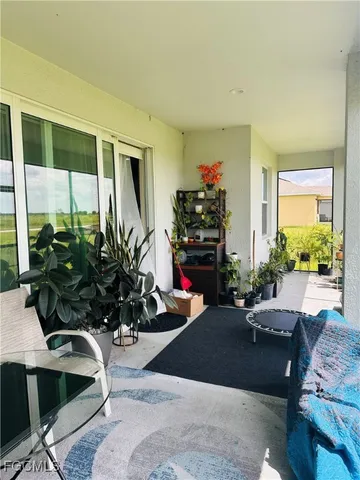 a living room with furniture gym equipment and a potted plant
