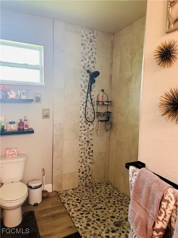 a bathroom with a toilet and shower