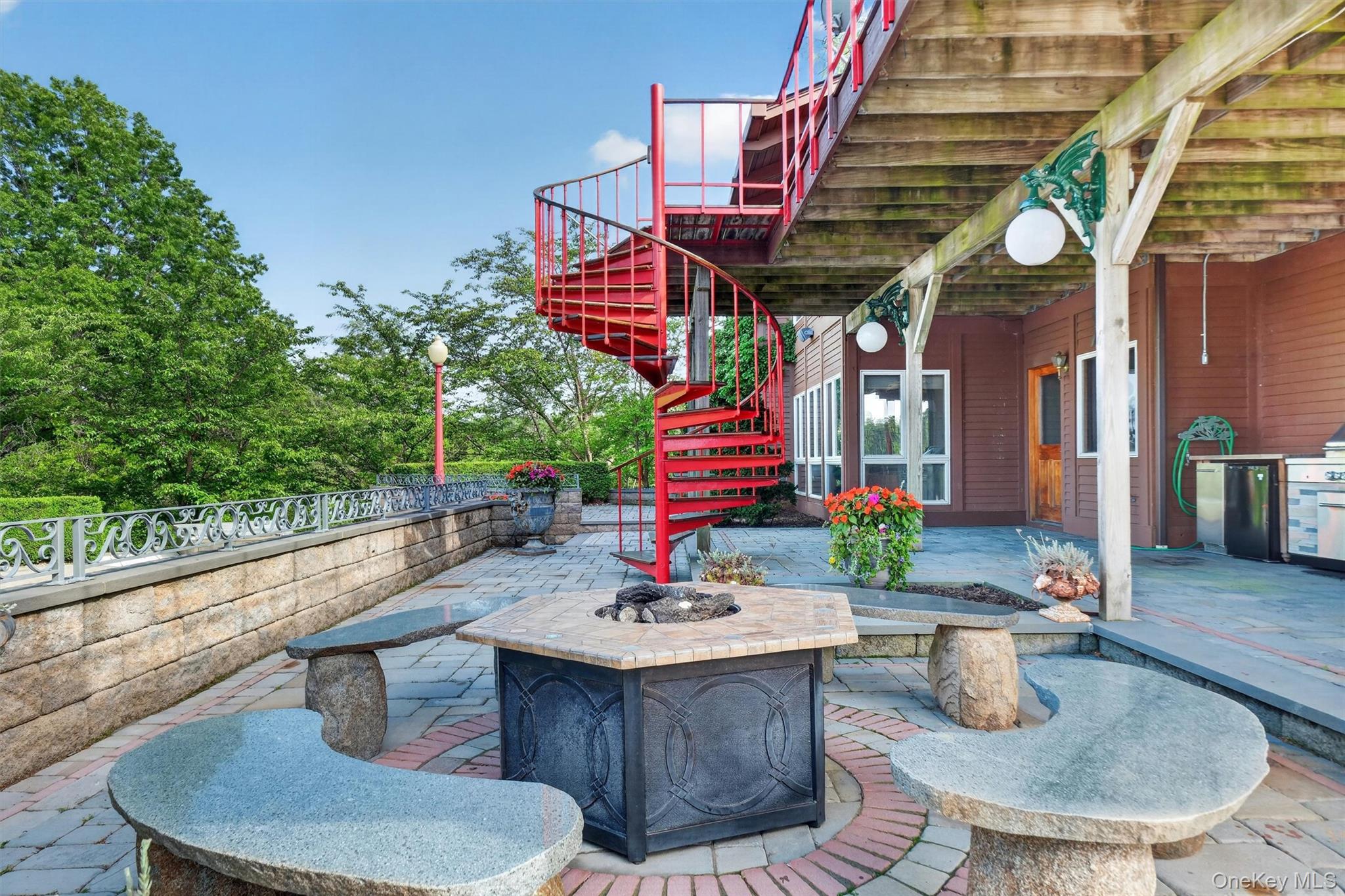 165 Hasbrouck Road Goshen, NY 10924 - Photo 11 of 50 Beautiful stone, tile and granite carved fire pit area by the pool. Note the spiral staircase from the top deck