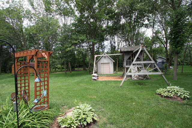 415 Rivers Edge Drive Minooka, IL 60447 - Photo 19 of 24 a view of a house with backyard and a tree