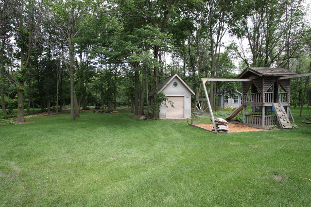 415 Rivers Edge Drive Minooka, IL 60447 - Photo 20 of 24 a view of a house with backyard and a slide