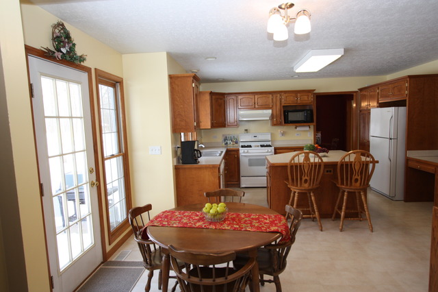 415 Rivers Edge Drive Minooka, IL 60447 - Photo 5 of 24 a dining room with furniture a window and a chandelier