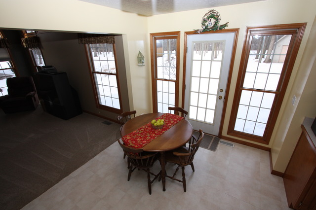 415 Rivers Edge Drive Minooka, IL 60447 - Photo 6 of 24 a view of a livingroom with furniture and windows
