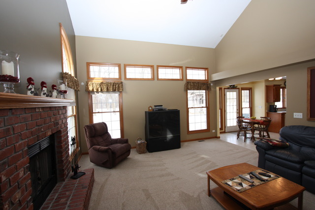 415 Rivers Edge Drive Minooka, IL 60447 - Photo 8 of 24 a living room with furniture and a fireplace