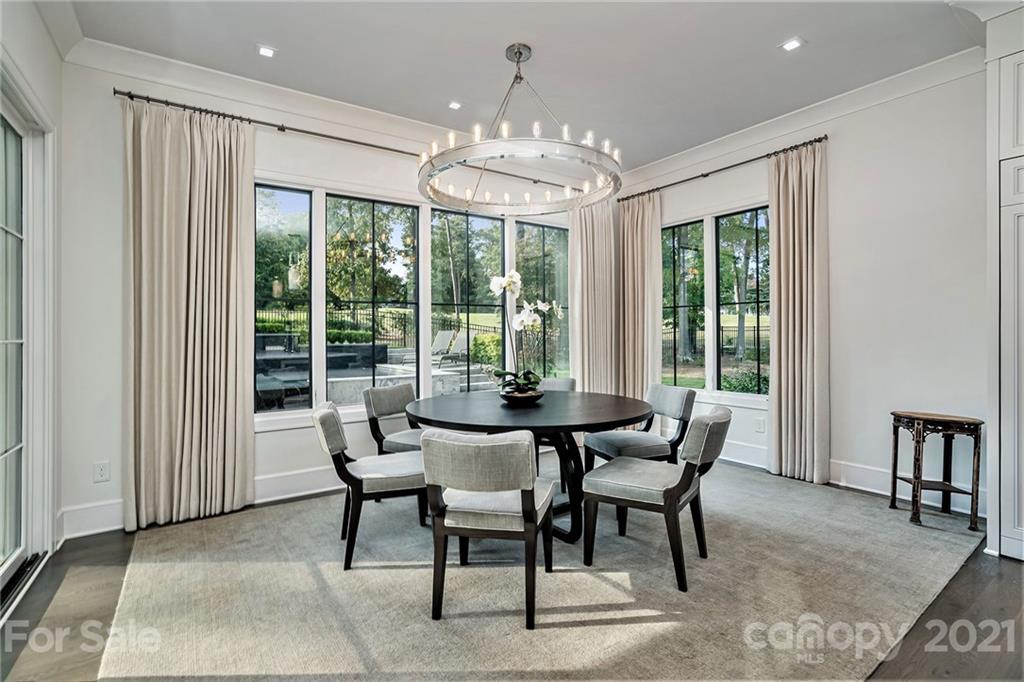 19053 Double Eagle Drive Cornelius, NC 28031 - Photo 13 of 43 a dining room with furniture a chandelier and wooden floor