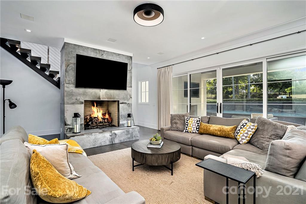 19053 Double Eagle Drive Cornelius, NC 28031 - Photo 16 of 43 a living room with furniture fireplace and a flat screen tv