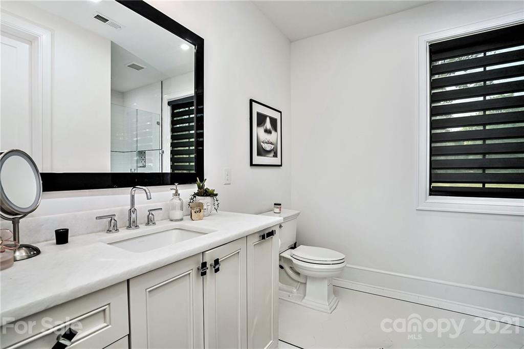 19053 Double Eagle Drive Cornelius, NC 28031 - Photo 20 of 43 a bathroom with a granite countertop sink a toilet and a mirror
