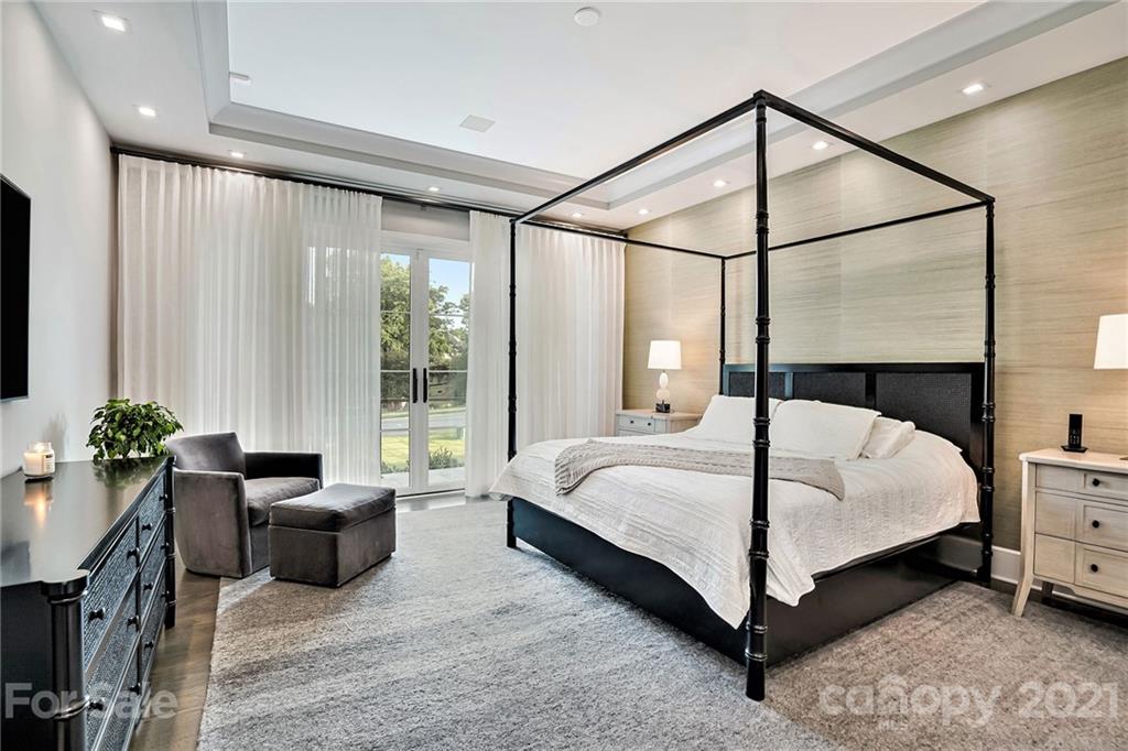 19053 Double Eagle Drive Cornelius, NC 28031 - Photo 21 of 43 a bedroom with a bed and potted plants next to a large window