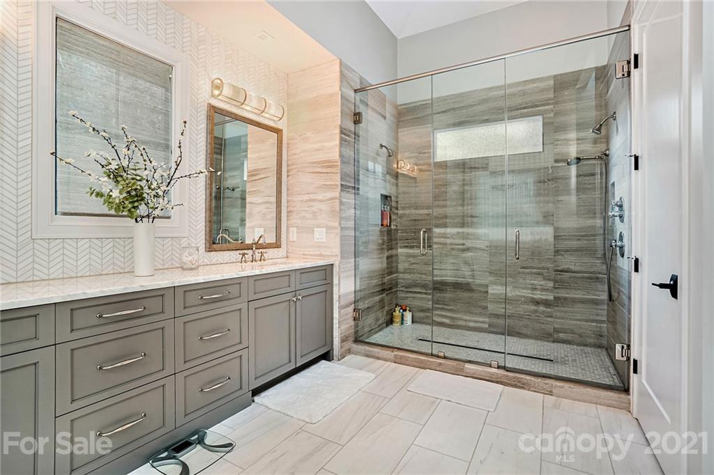 19053 Double Eagle Drive Cornelius, NC 28031 - Photo 27 of 43 a bathroom with a shower sink and mirror