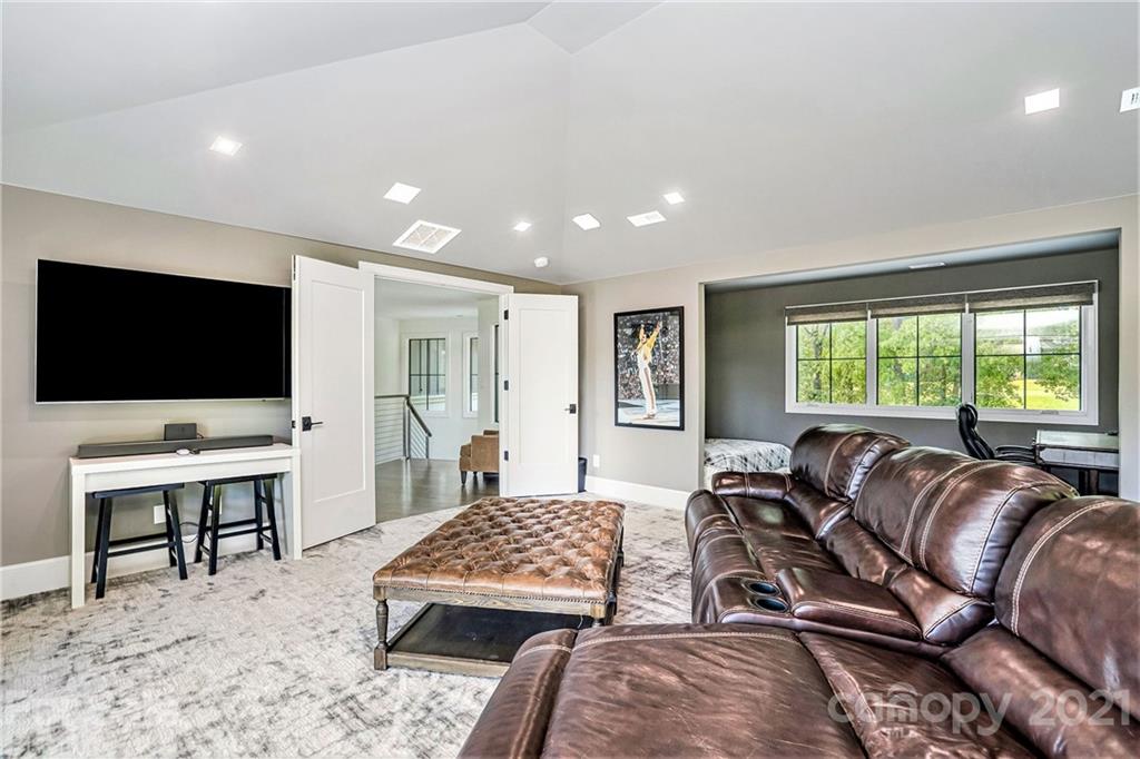 19053 Double Eagle Drive Cornelius, NC 28031 - Photo 8 of 43 a living room with furniture and a flat screen tv