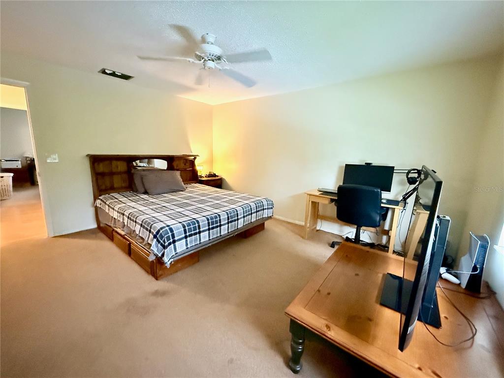 4805 Rilma Avenue, Unit 102 Sarasota, FL 34234 - Photo 11 of 18 a bedroom with a bed and a desk