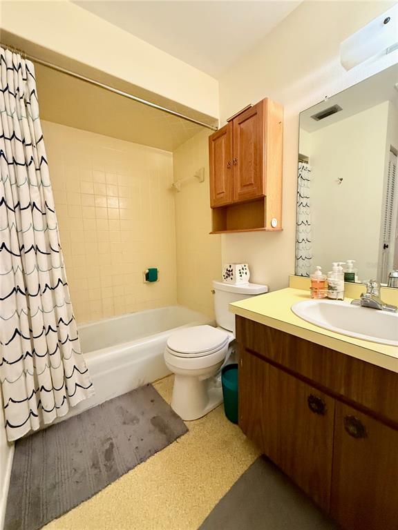 4805 Rilma Avenue, Unit 102 Sarasota, FL 34234 - Photo 13 of 18 a bathroom with a sink a toilet and shower
