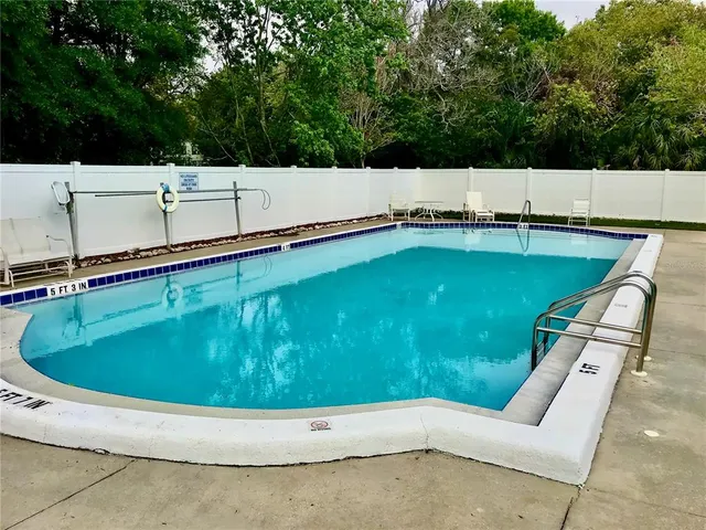 a view of a swimming pool with a yard
