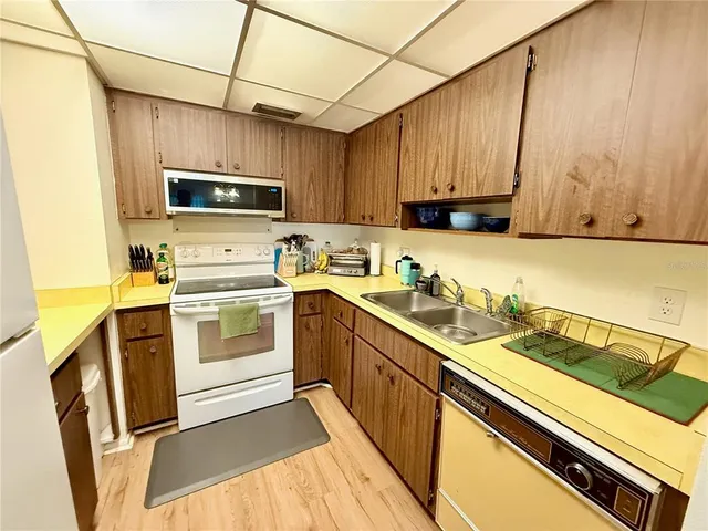 a kitchen with stainless steel appliances a stove a sink a microwave and cabinets