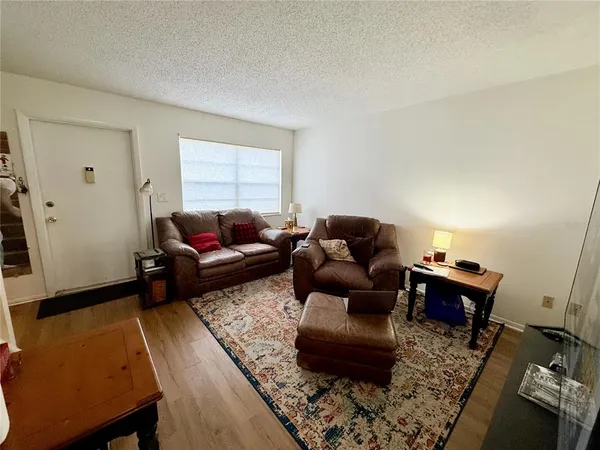 a living room with furniture and wooden floor