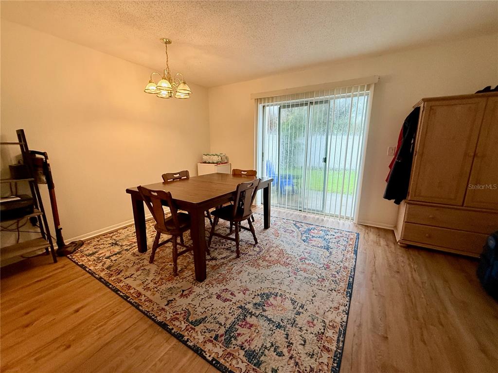 4805 Rilma Avenue, Unit 102 Sarasota, FL 34234 - Photo 5 of 18 a view of a dining room with furniture window and wooden floor