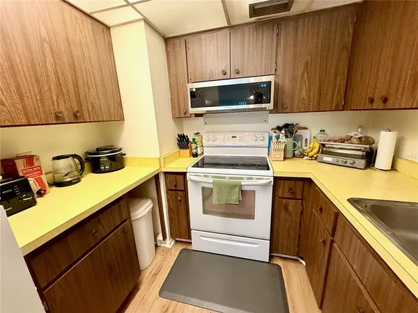 a kitchen with a sink stove and microwave