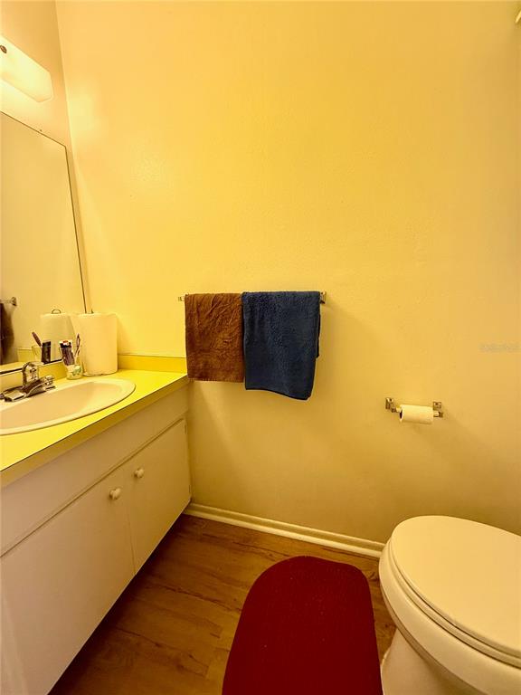4805 Rilma Avenue, Unit 102 Sarasota, FL 34234 - Photo 8 of 18 a bathroom with a toilet a sink and a mirror