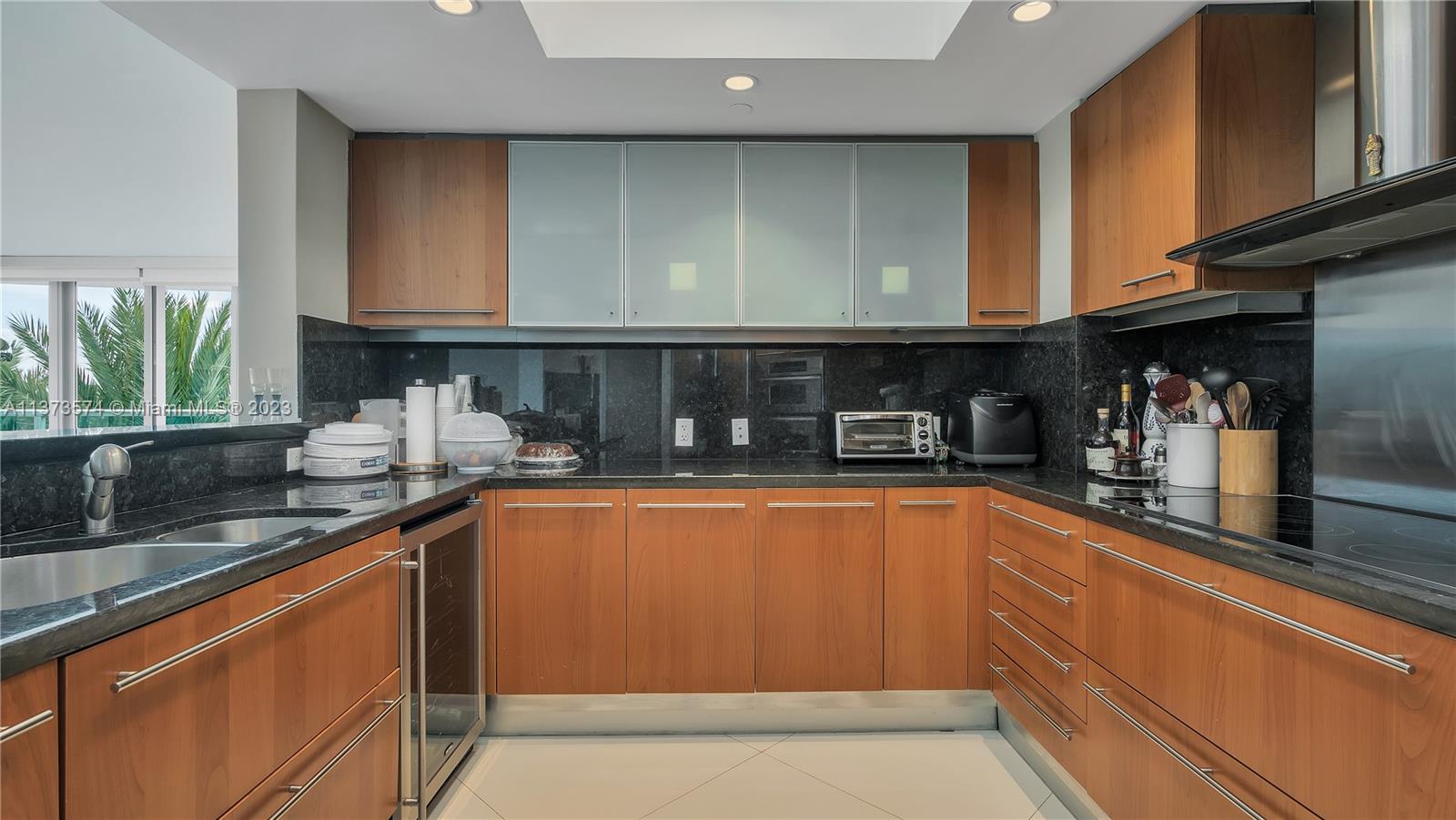 9401 Collins Avenue, Unit 402 Surfside, FL 33154 - Photo 16 of 31 a kitchen with stainless steel appliances granite countertop a sink and cabinets