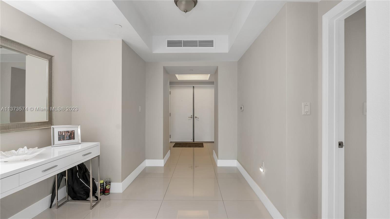 9401 Collins Avenue, Unit 402 Surfside, FL 33154 - Photo 20 of 31 a bathroom with a sink and a mirror