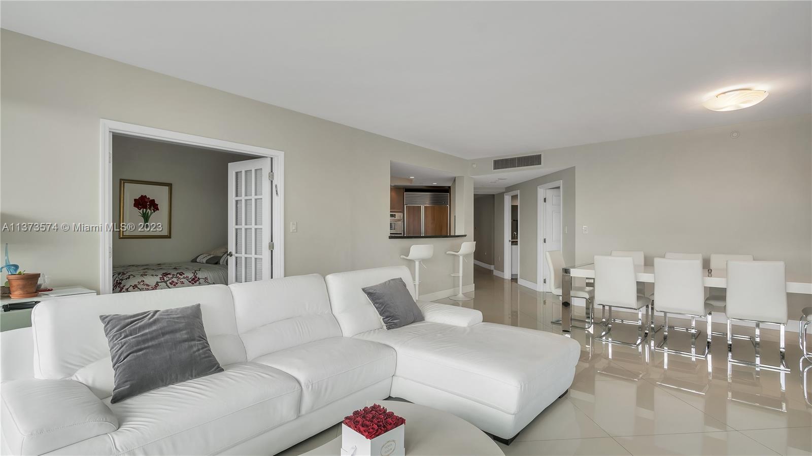 9401 Collins Avenue, Unit 402 Surfside, FL 33154 - Photo 22 of 31 a living room with furniture and a table