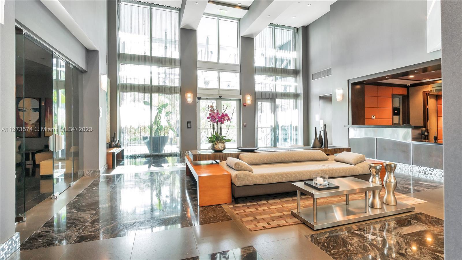 9401 Collins Avenue, Unit 402 Surfside, FL 33154 - Photo 23 of 31 a living room with furniture and a large window