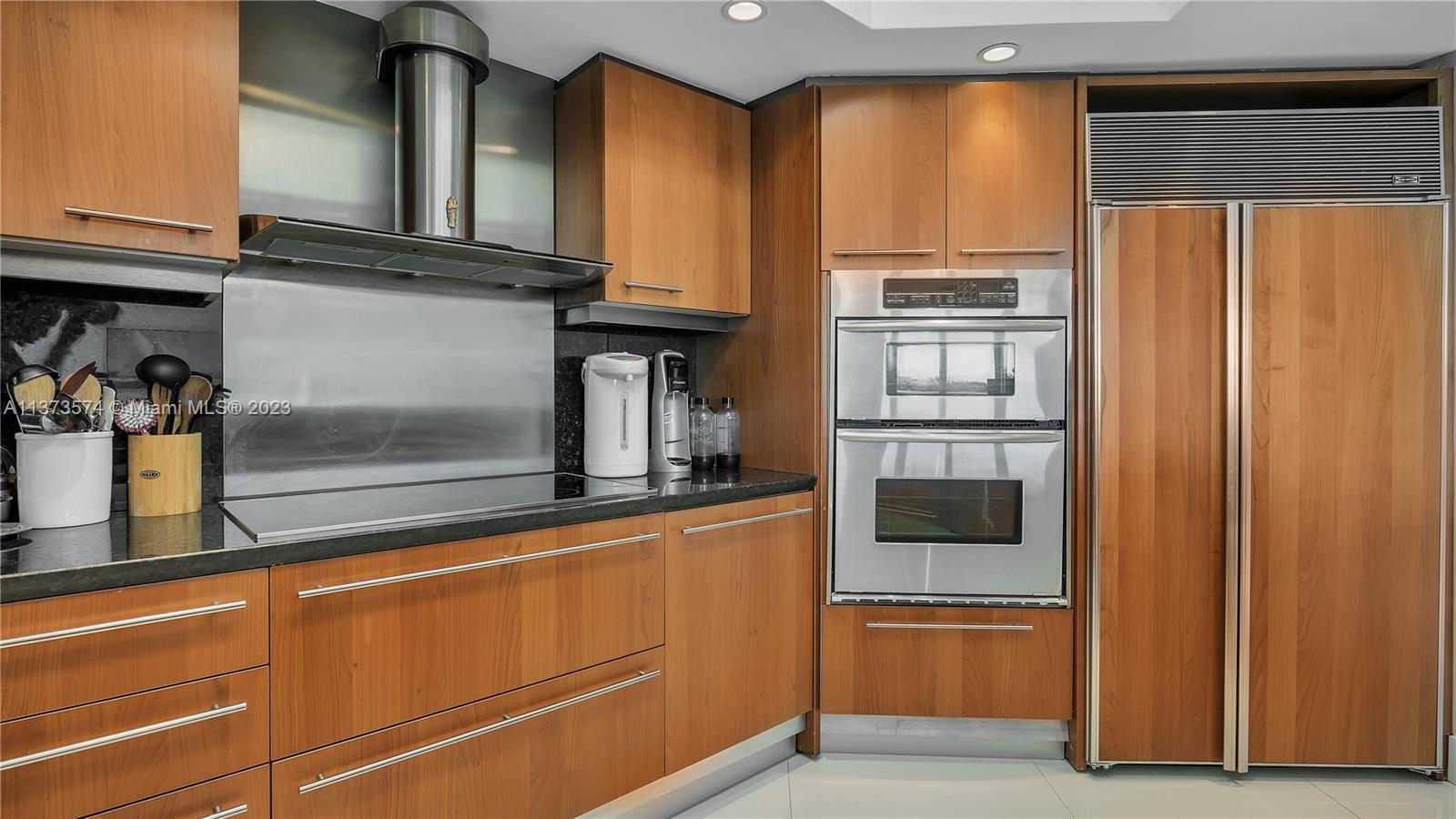 9401 Collins Avenue, Unit 402 Surfside, FL 33154 - Photo 8 of 31 a kitchen with stainless steel appliances granite countertop a refrigerator and a sink