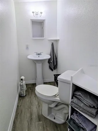 a bathroom with a sink toilet and a mirror
