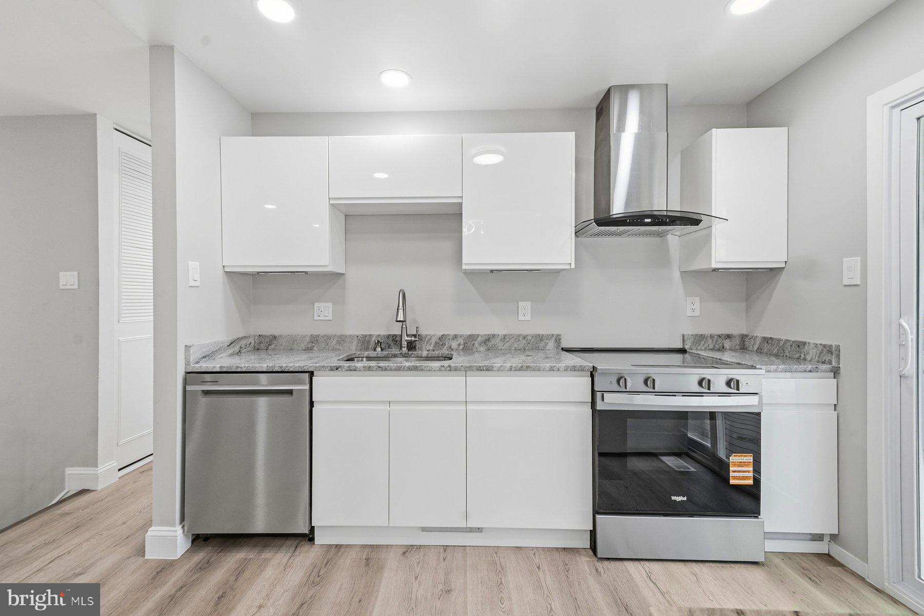 6301 Linus Drive Baltimore, MD 21207 - Photo 17 of 38 a kitchen with stainless steel appliances granite countertop a stove and white cabinets