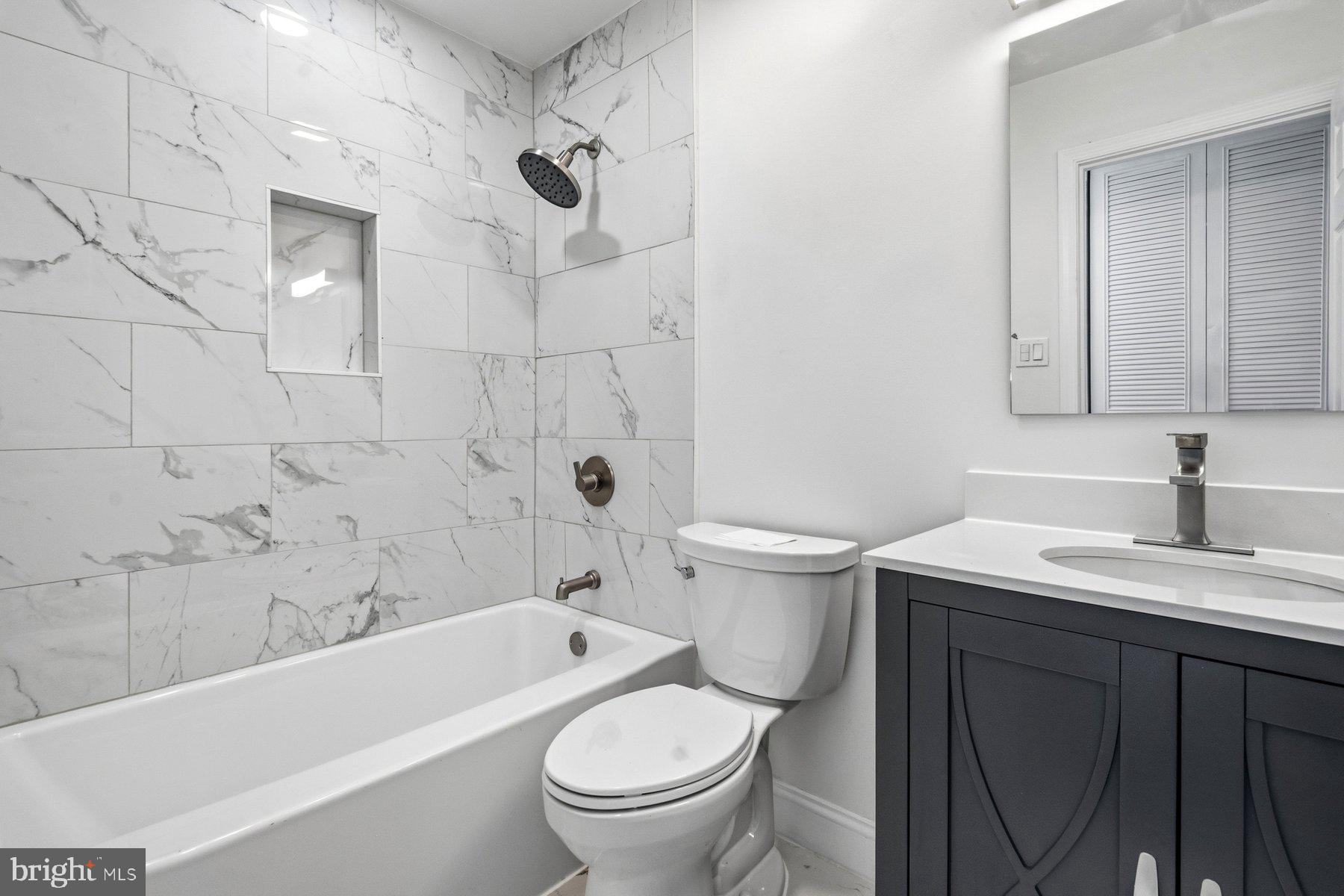 6301 Linus Drive Baltimore, MD 21207 - Photo 22 of 38 a bathroom with a sink a toilet and a bathtub