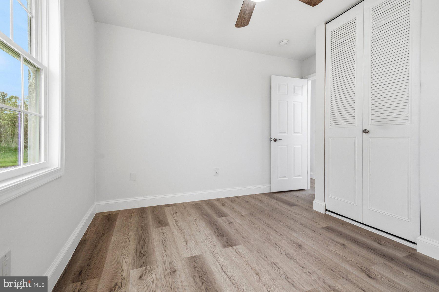 6301 Linus Drive Baltimore, MD 21207 - Photo 23 of 38 an empty room with wooden floor and windows