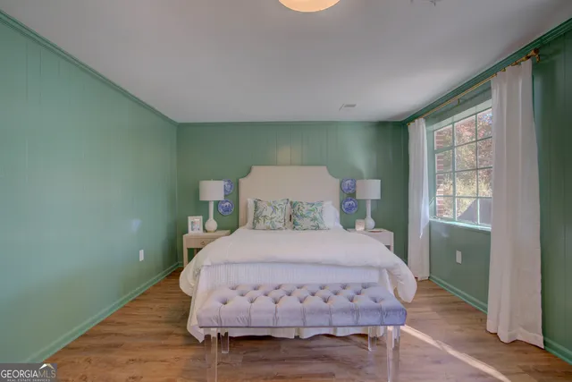 a bedroom with a bed window and a table