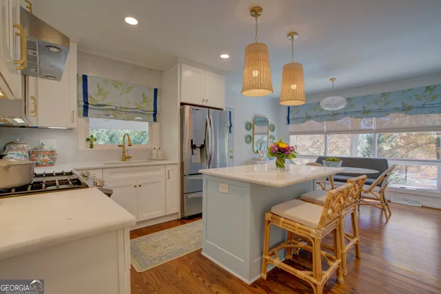 a kitchen with a sink appliances and cabinets