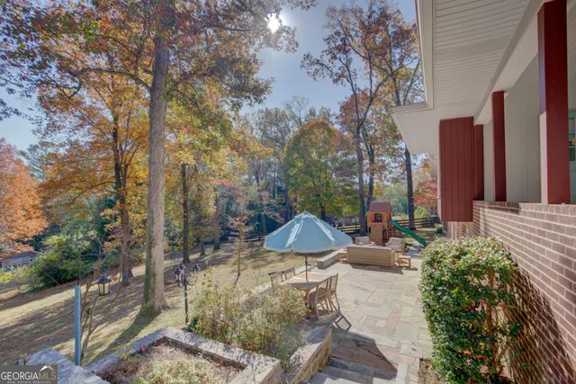 a view of backyard with seating area and green space