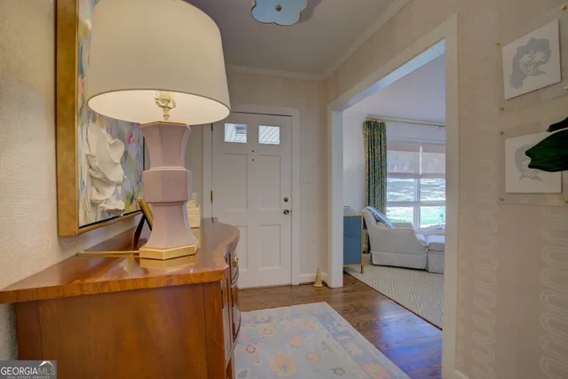a view of a hallway with entryway wooden floor and front door